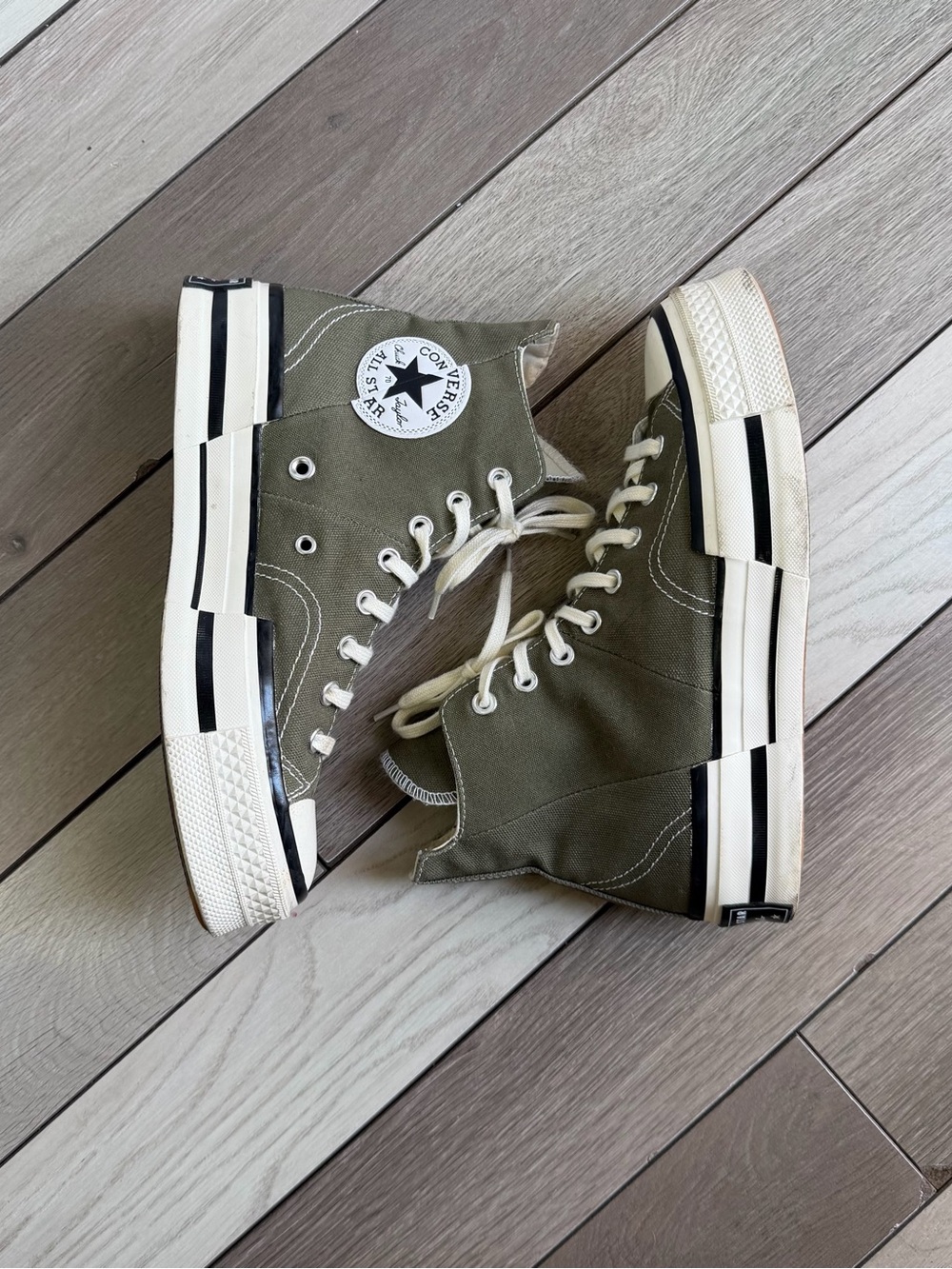 Converse Chuck 70 Plus high-top sneakers in an olive green